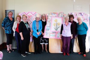 The Nathan Homestead Quilting Group with their stunning quilts